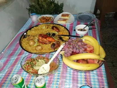 a table topped with plates of food and fruit at family studio in Wadi Musa