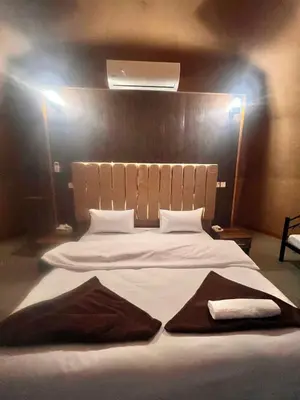 a large white bed with two towels on it at Allen Luxury Wadi Rum in Wadi Rum