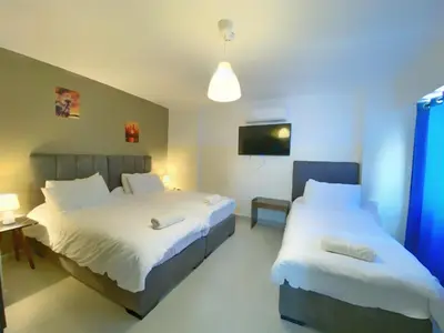 a hotel room with two beds and a tv at The Castle Star in Amman