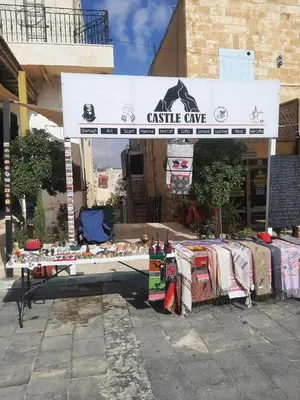 a market with a table in front of a building at Beit alkaram in Kerak
