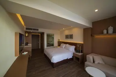 a hotel room with a bed and a couch at Luxotel Aqaba Beach Resort & Spa Only 15 years plus in Aqaba