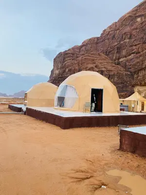two domes in the desert with a mountain in the background at Wadi Rum beautiful time in Wadi Rum