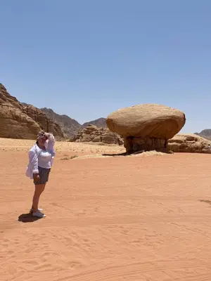 a woman taking a picture in the desert at Wadi Rum beautiful time in Wadi Rum