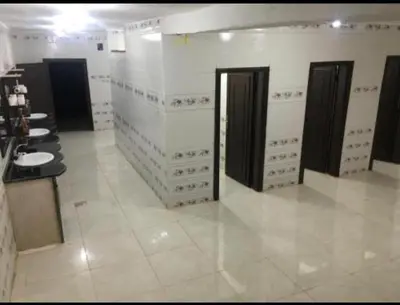 a large bathroom with sinks and stalls in a building at Wadi rum under stars in Wadi Rum