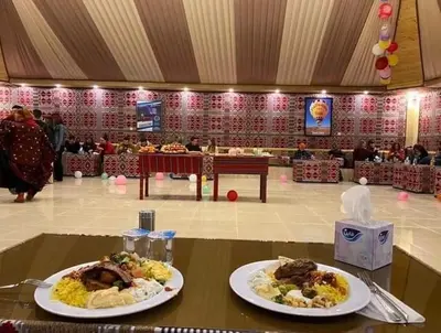 two plates of food on a table in a room at Wadi rum under stars in Wadi Rum