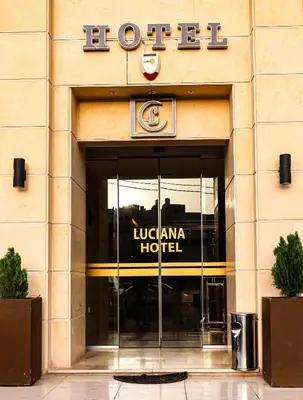 a building with a hotel sign on the door at Luciana Hotel by FHM in Aqaba