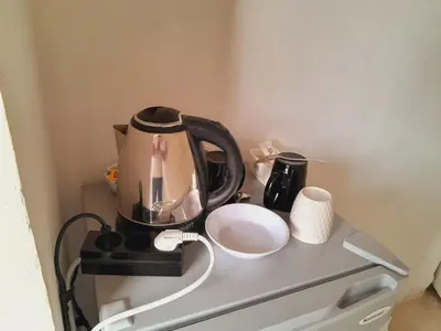 a tea kettle and a cup on a shelf at Aun Wadi Rum Camp in Wadi Rum