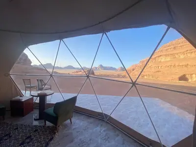a tent with a view of the desert at Aun Wadi Rum Camp in Wadi Rum