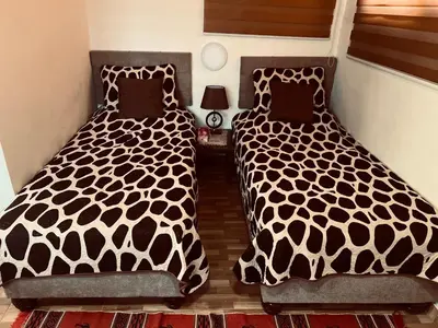 two beds sitting next to each other in a bedroom at IBN Khaldoon in Madaba