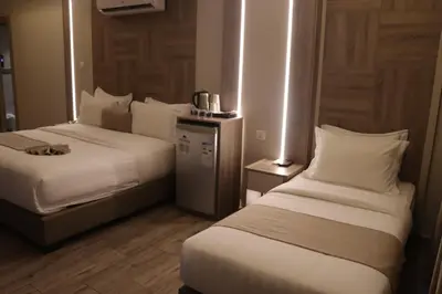 a hotel room with two beds in a room at ALENA HOTEL in Aqaba
