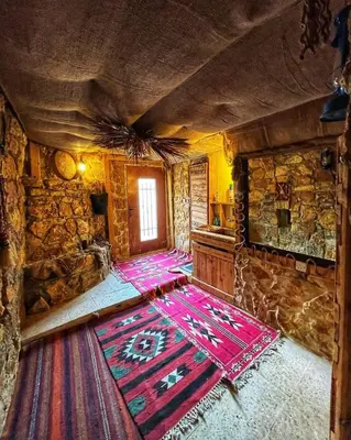 a room with a colorful rug on the floor in a building at 7 Caves Hotel in Al Jāyah