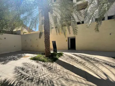 a palm tree in front of a building at Al Raha Village - Aqaba in Aqaba