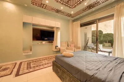 a bedroom with a bed and a living room at Al Raha Village - Aqaba in Aqaba