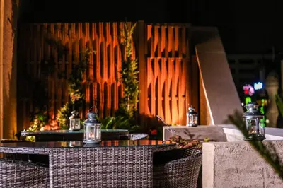 a couple of tables and chairs in a restaurant at Khuttar Apartment in Amman