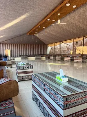a large lobby with a table in the middle of a room at Star Magic Camp in Wadi Rum