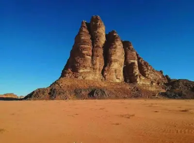 a group of large rock formations in the desert at Star Magic Camp in Wadi Rum
