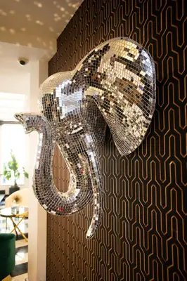 a large chandelier is hanging from a wall at Hotel Philosophy in Amman