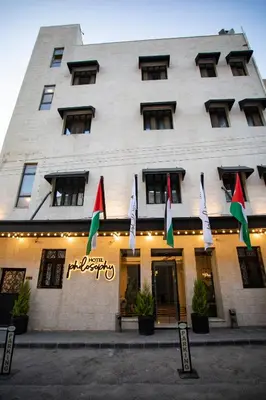 a building with flags in front of it at Hotel Philosophy in Amman