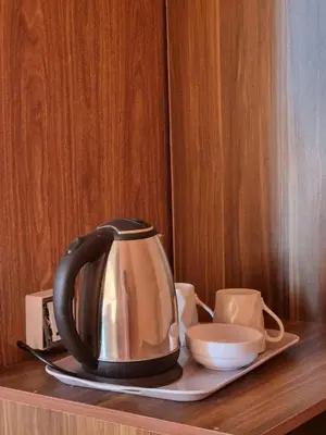 a tea kettle on a plate on a wooden table at Kylie magic camp in Wadi Rum