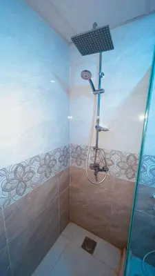 a bathroom with a shower with a bicycle in it at Kylie magic camp in Wadi Rum