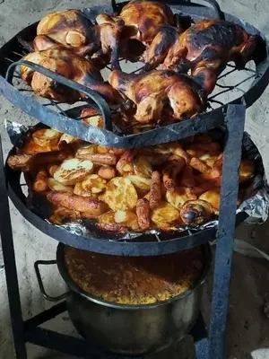 a bunch of chickens are cooking on a grill at Kylie magic camp in Wadi Rum