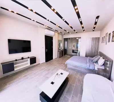 a living room with a bed and a tv at laperla chalet villa di lusso deadsea in Sowayma