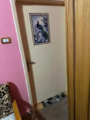 a door in a room with a picture on the wall at Jordanian Baity Apartment in Wadi Musa