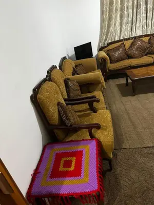 a living room with two couches and a rug at Jordanian Baity Apartment in Wadi Musa