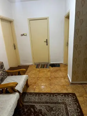 a room with a door and a couch and a rug at Jordanian Baity Apartment in Wadi Musa