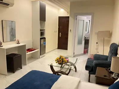 a living room with a couch and a table at Uptown Hotel Apartment in Amman
