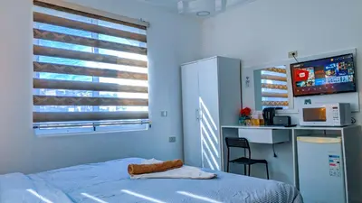 a bedroom with a bed and a desk and a window at Full panorama Jerash (PLUS) in Jerash