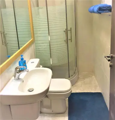 a bathroom with a toilet and a sink and a shower at The Royal Luxury Superior Queen cot in Amman