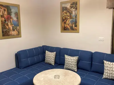 a blue couch with a table in a room at The Royal Luxury Superior Queen cot in Amman