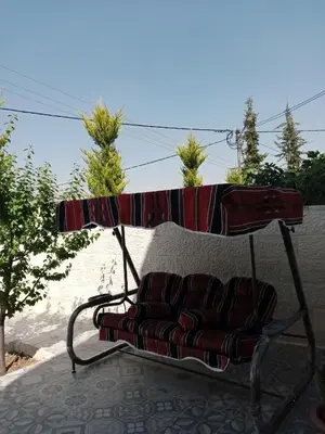 a couch sitting under a table on a patio at Jerash air apartment in Jerash
