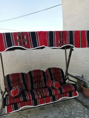 a couch sitting under a table in a living room at Jerash air apartment in Jerash