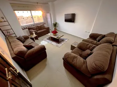 a large living room with couches and a tv at Petra Cloud 1977 in Wadi Musa