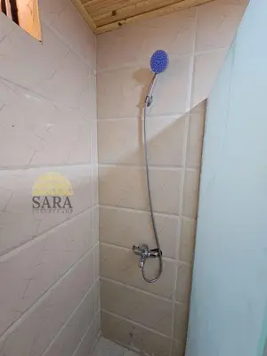 a shower with a shower head in a bathroom at SARA lUXURY CAMP in Wadi Rum