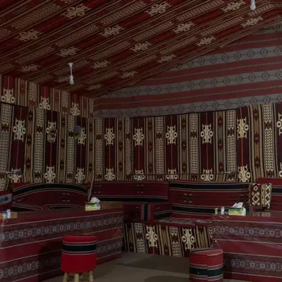a room with a red and white patterned wall at The sun of Wadi Rum camp in Wadi Rum