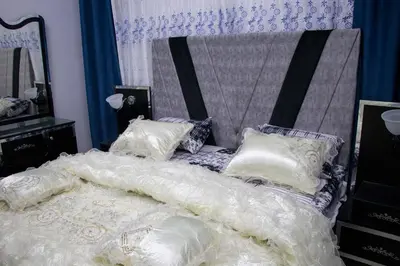 a bedroom with a bed with white comforter and pillows at Blue House in Aqaba