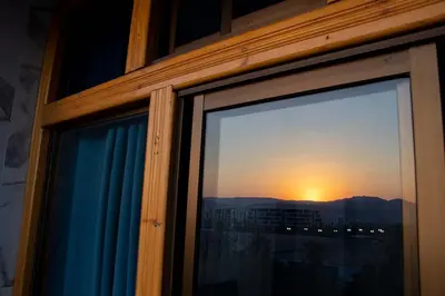 a view of a sunset from a window at Blue House in Aqaba