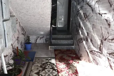 a hallway with a staircase with a tile floor at Blue House in Aqaba