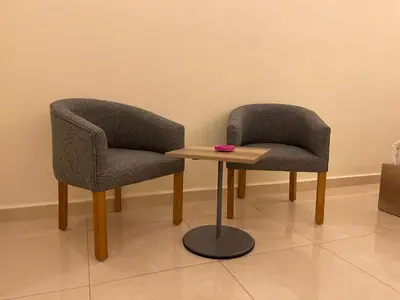 two chairs and a table in a room at Aster Hotel Aqaba in Aqaba