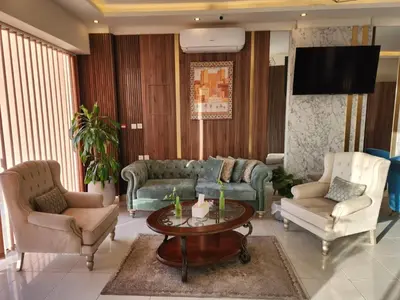 a living room with two couches and a table at Aster Hotel Aqaba in Aqaba