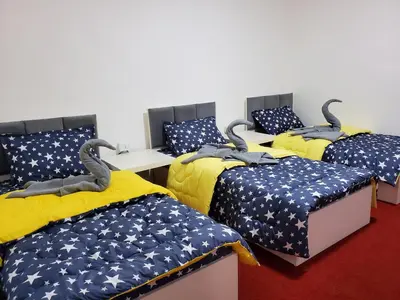 a group of four beds in a room at petra Casablanca lodge in Wadi Musa