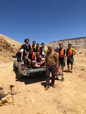 a group of people sitting on the back of a truck at Alhidan Hostel & adventure in Madaba