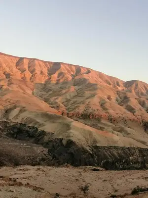 a mountain covered in dirt and rocks in the desert at Alhidan Hostel & adventure in Madaba