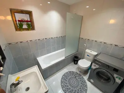 a bathroom with a sink and a washing machine at Lovely 3-bedrooms rental unit in Aqaba