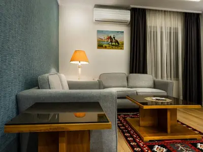 a living room with a couch and a table at Prestige Hotel Suites - برستيج للشقق الفندقية in Amman
