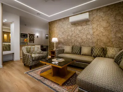 a living room with a couch and a table at Prestige Hotel Suites - برستيج للشقق الفندقية in Amman