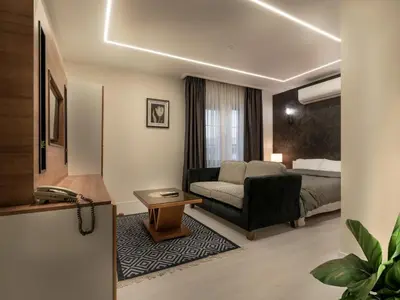 a hotel room with a couch and a bed at Prestige Hotel Suites - برستيج للشقق الفندقية in Amman